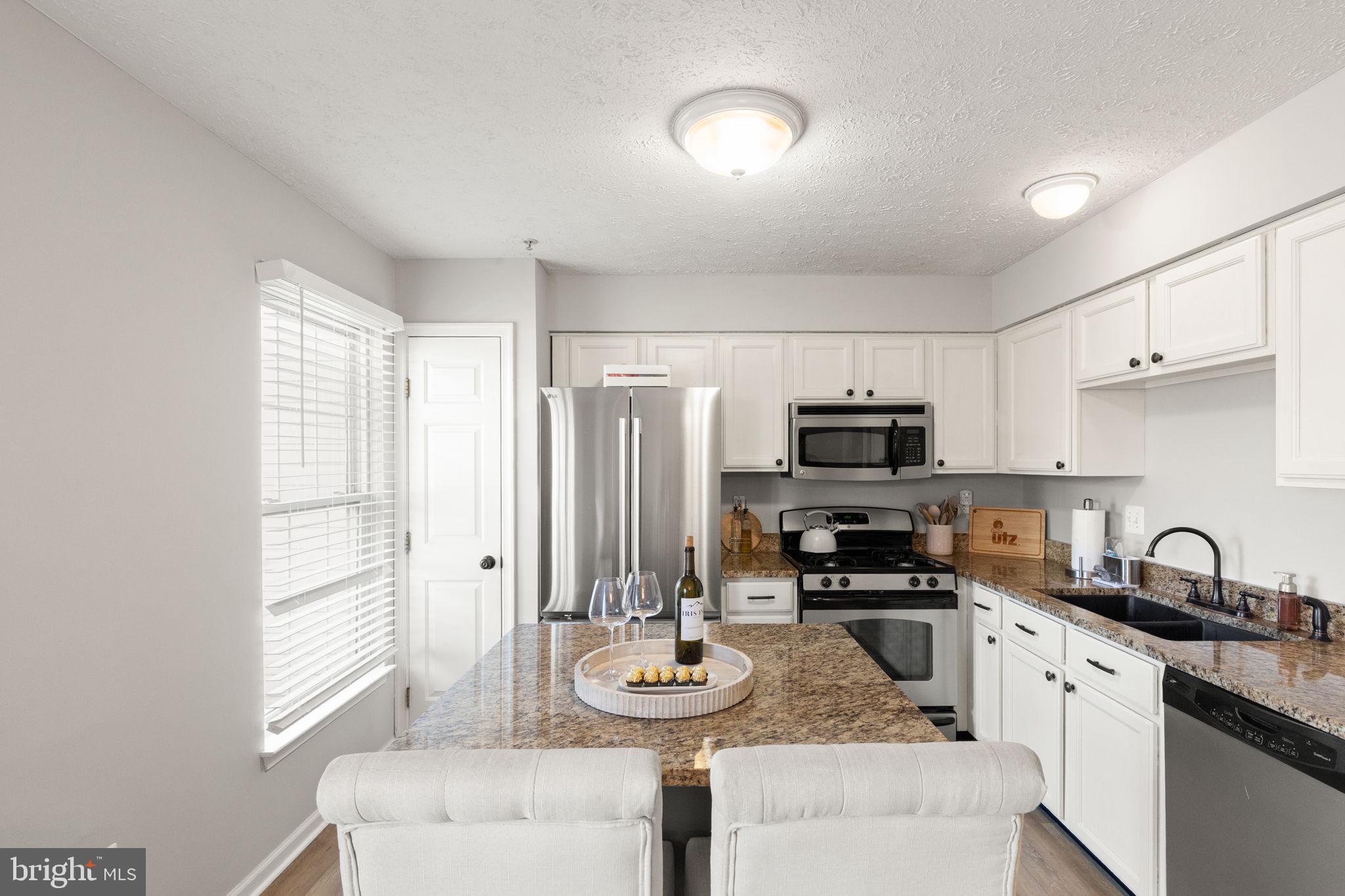 488 Crestridge Way Abingdon, MD 21009 - Photo 3 of 22 a kitchen with granite countertop a sink stainless steel appliances and cabinets