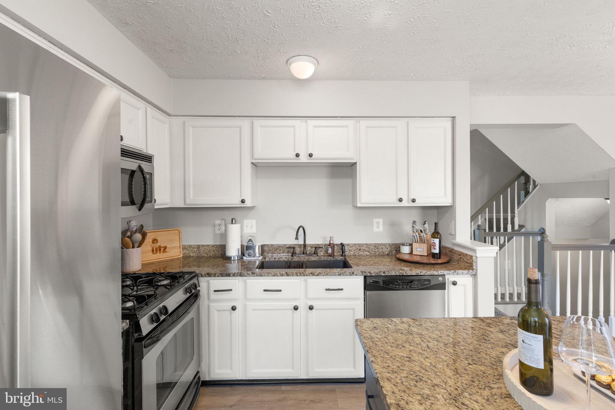 488 Crestridge Way Abingdon, MD 21009 - Photo 4 of 22 a kitchen with white cabinets and appliances