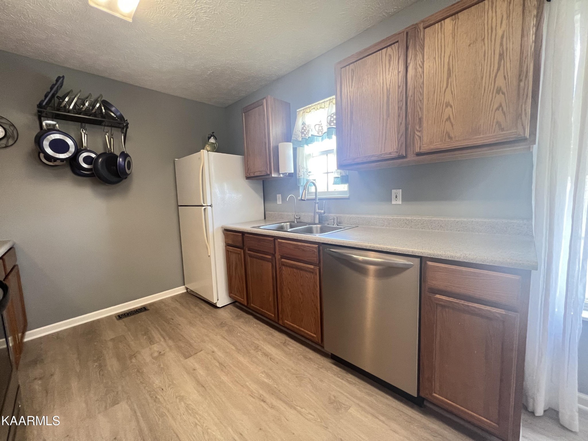 114 Bishop Street Alcoa, TN 37701 - Photo 11 of 20 a kitchen with a refrigerator and a stove top oven