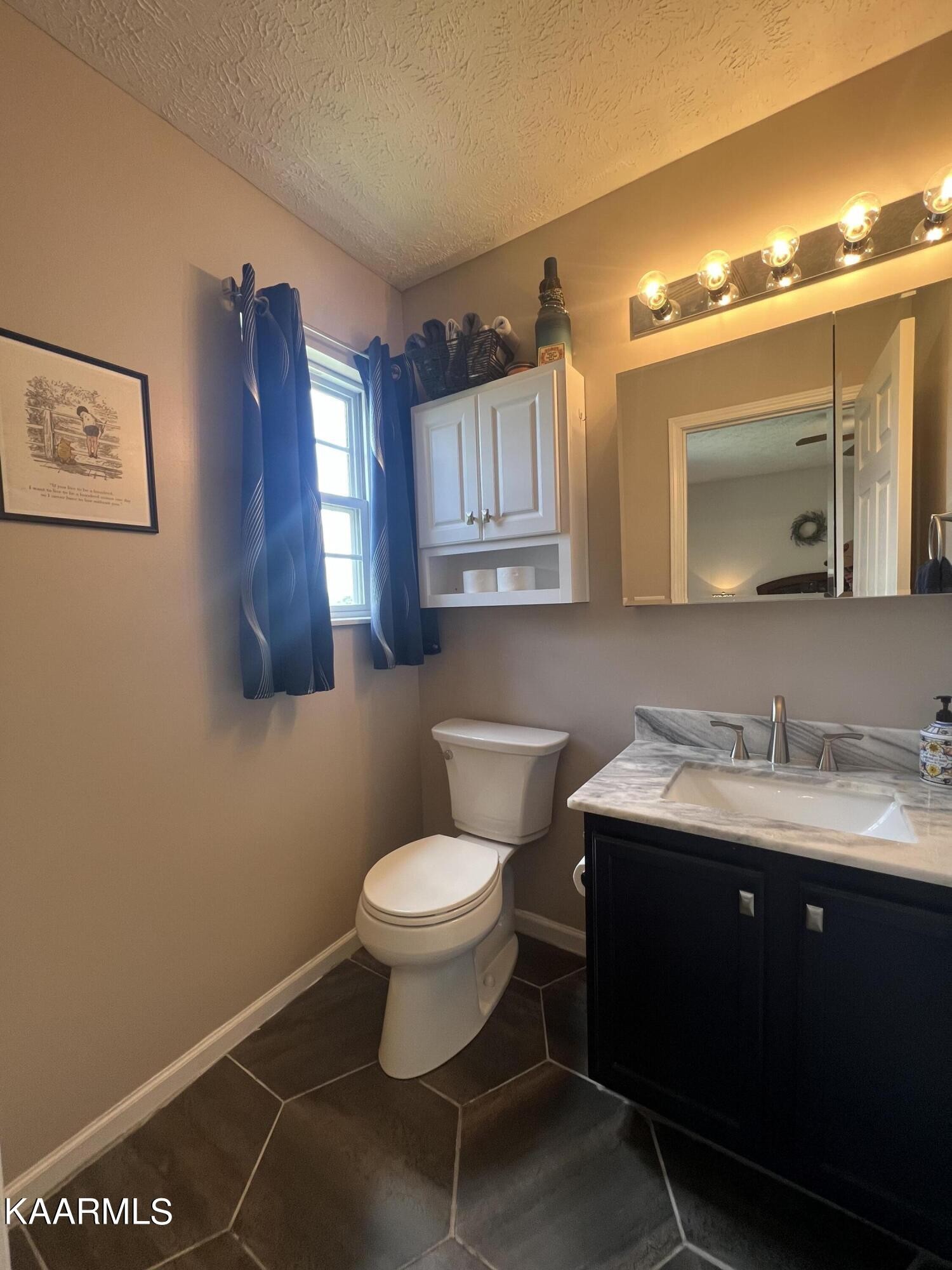 114 Bishop Street Alcoa, TN 37701 - Photo 19 of 20 a bathroom with a toilet sink and mirror