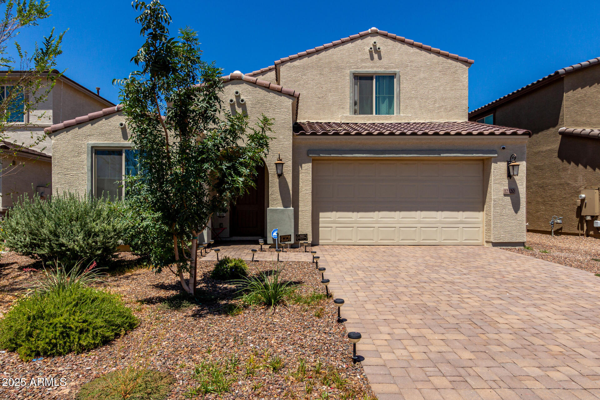 12120 West Pkwy Lane Avondale, AZ 85323 - Photo 2 of 45 a front view of a house with garden
