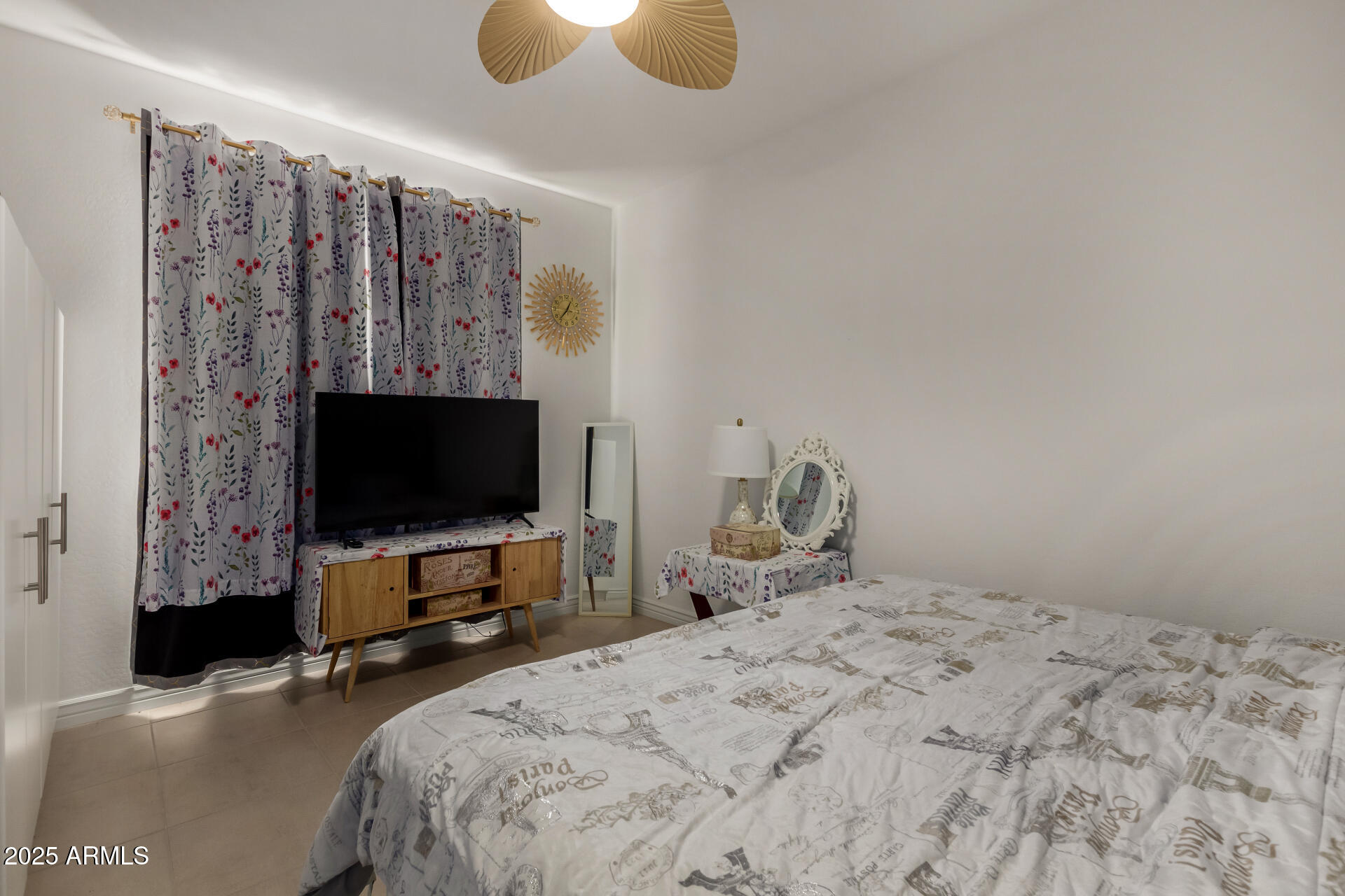 12120 West Pkwy Lane Avondale, AZ 85323 - Photo 24 of 45 a bedroom with a bed and a flat tv screen on dresser