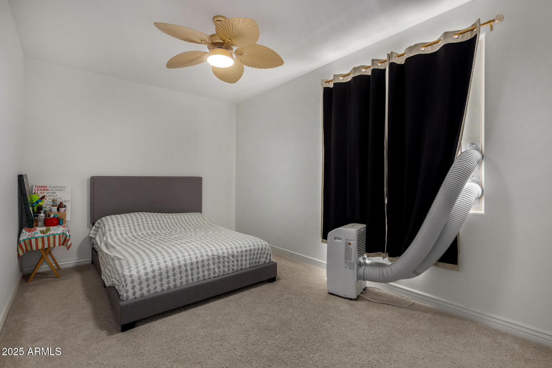 12120 West Pkwy Lane Avondale, AZ 85323 - Photo 29 of 45 a bedroom with a bed and a chandelier