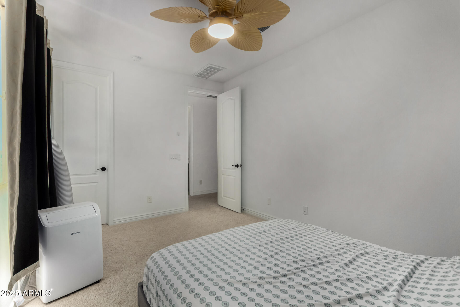 12120 West Pkwy Lane Avondale, AZ 85323 - Photo 30 of 45 a bedroom with a bed and a chandelier