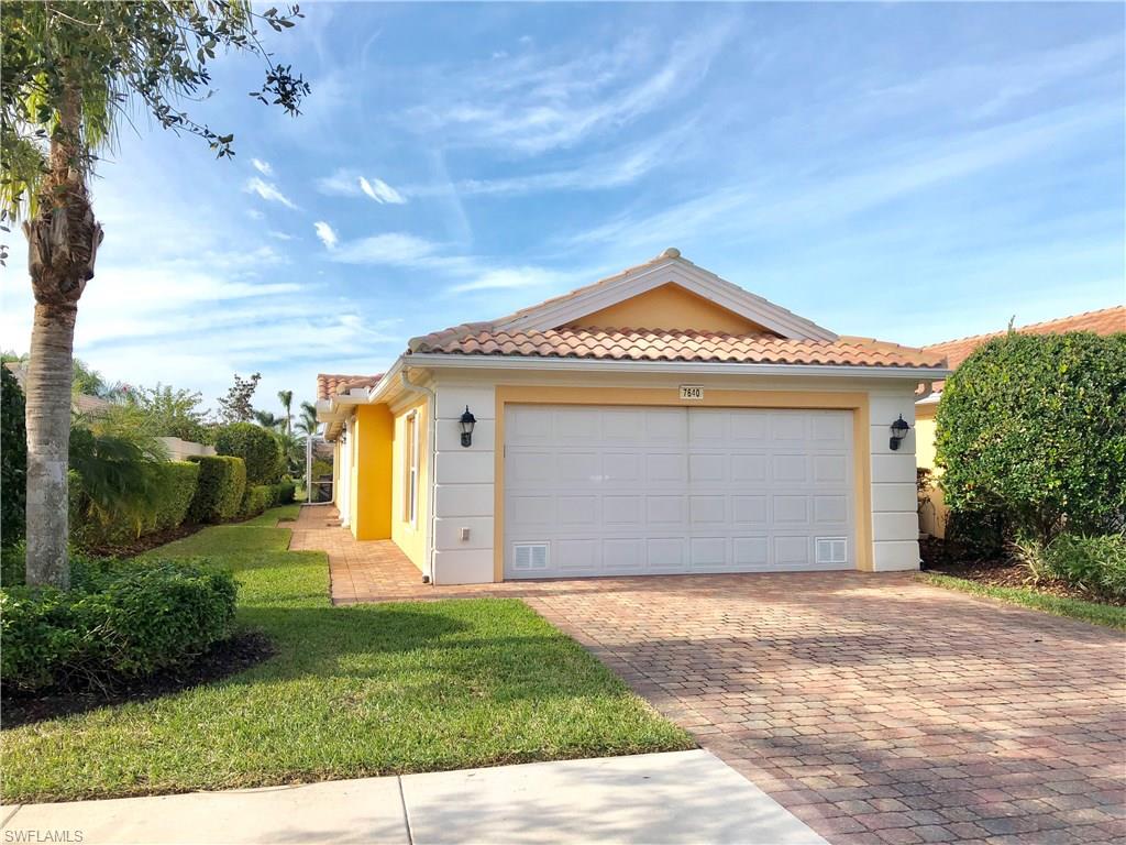 7640 Rozzini Lane Naples, FL 34114 - Photo 1 of 17 a front view of a house with a yard