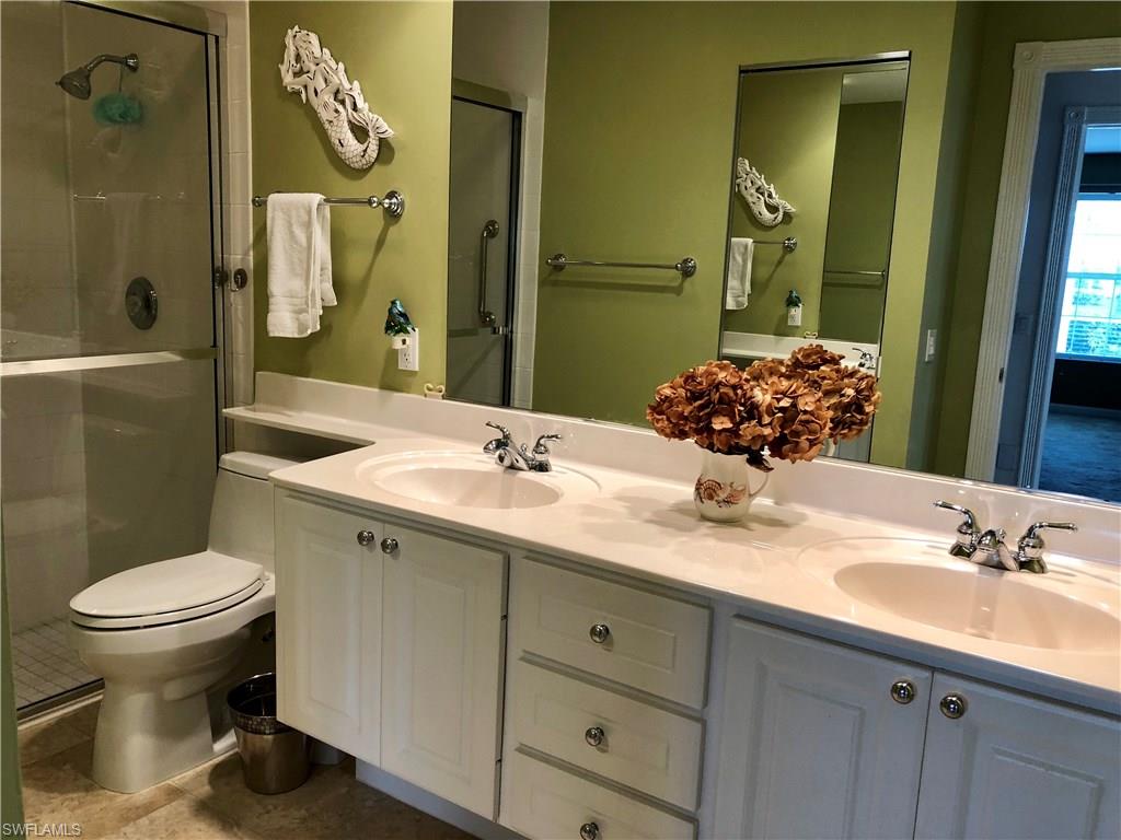 7640 Rozzini Lane Naples, FL 34114 - Photo 11 of 17 a bathroom with a granite countertop sink toilet and shower