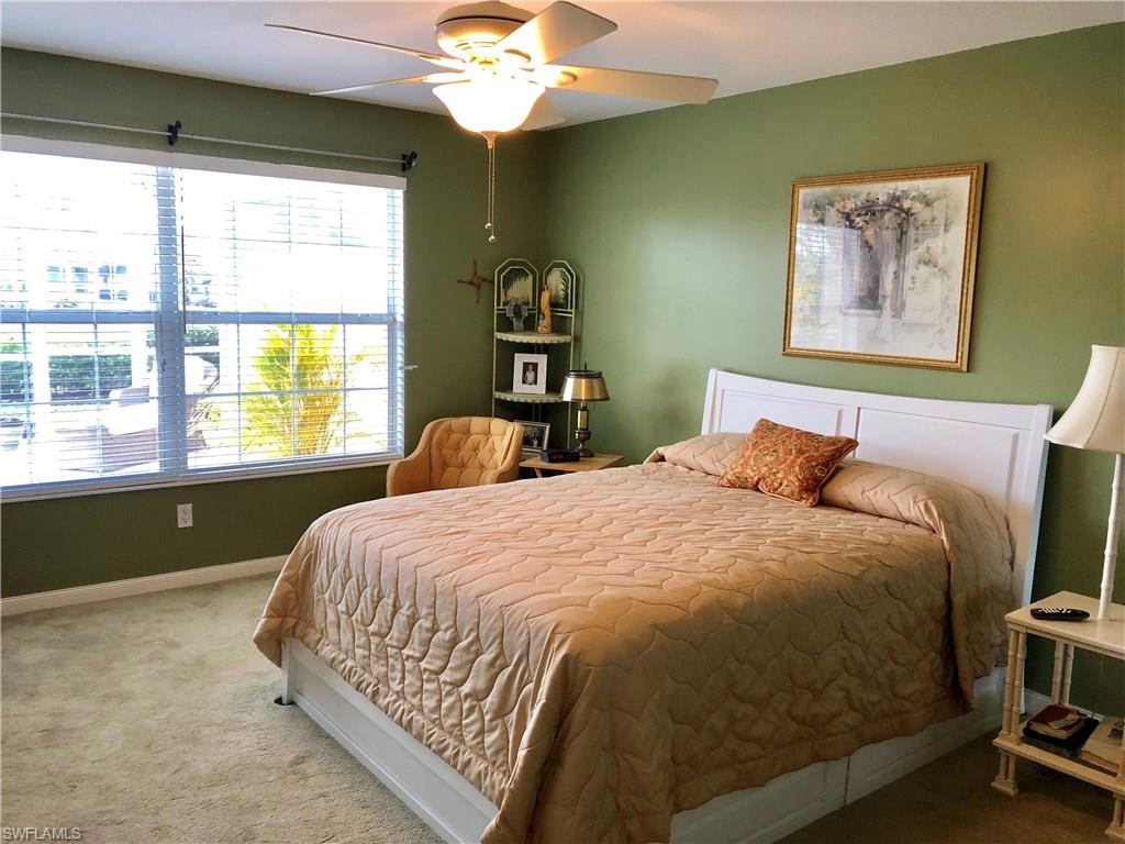 7640 Rozzini Lane Naples, FL 34114 - Photo 12 of 17 a bedroom with a bed and a window