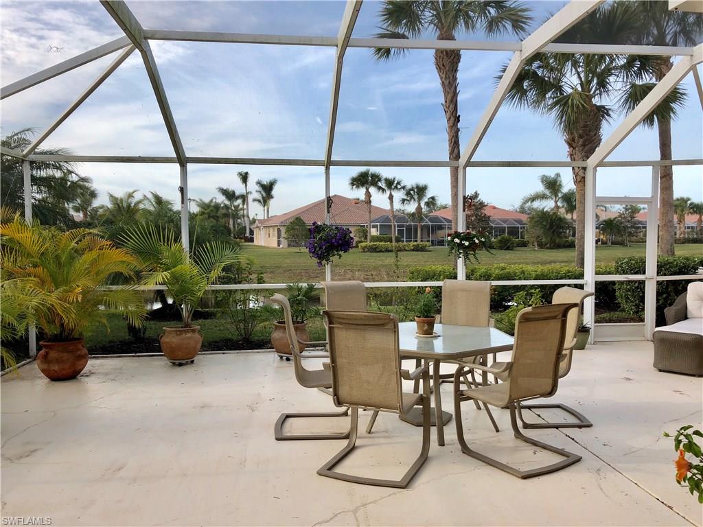 7640 Rozzini Lane Naples, FL 34114 - Photo 16 of 17 a view of a patio with a table chairs and a table