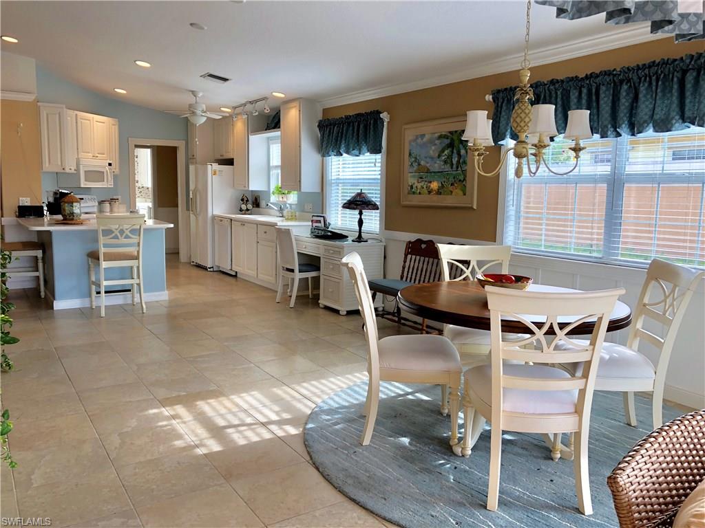 7640 Rozzini Lane Naples, FL 34114 - Photo 4 of 17 a view of a dining room with furniture