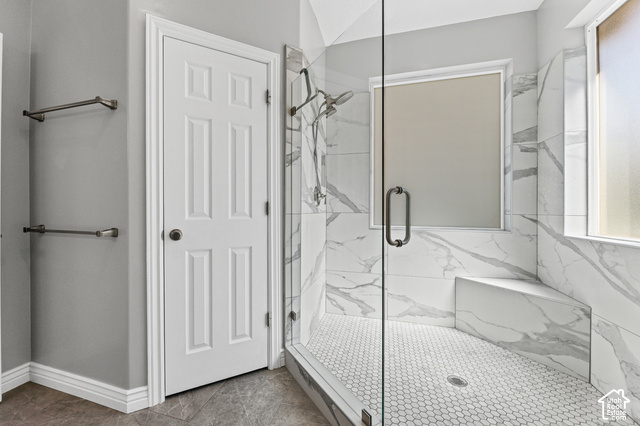 14038 New Saddle Road Draper, UT 84020 - Photo 15 of 46 Glass-enclosed shower with white hexagon tile flooring, white marble-look tile walls, and a built-in shower bench