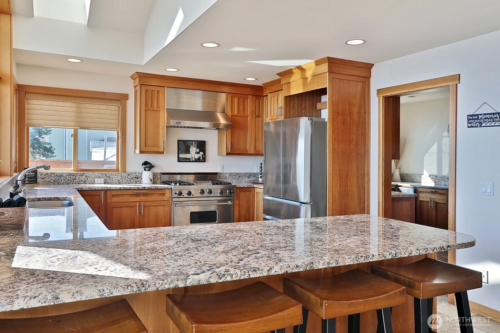 4913 Marshall Road Clinton, WA 98236 - Photo 20 of 40 a kitchen with stainless steel appliances granite countertop a stove refrigerator and cabinets