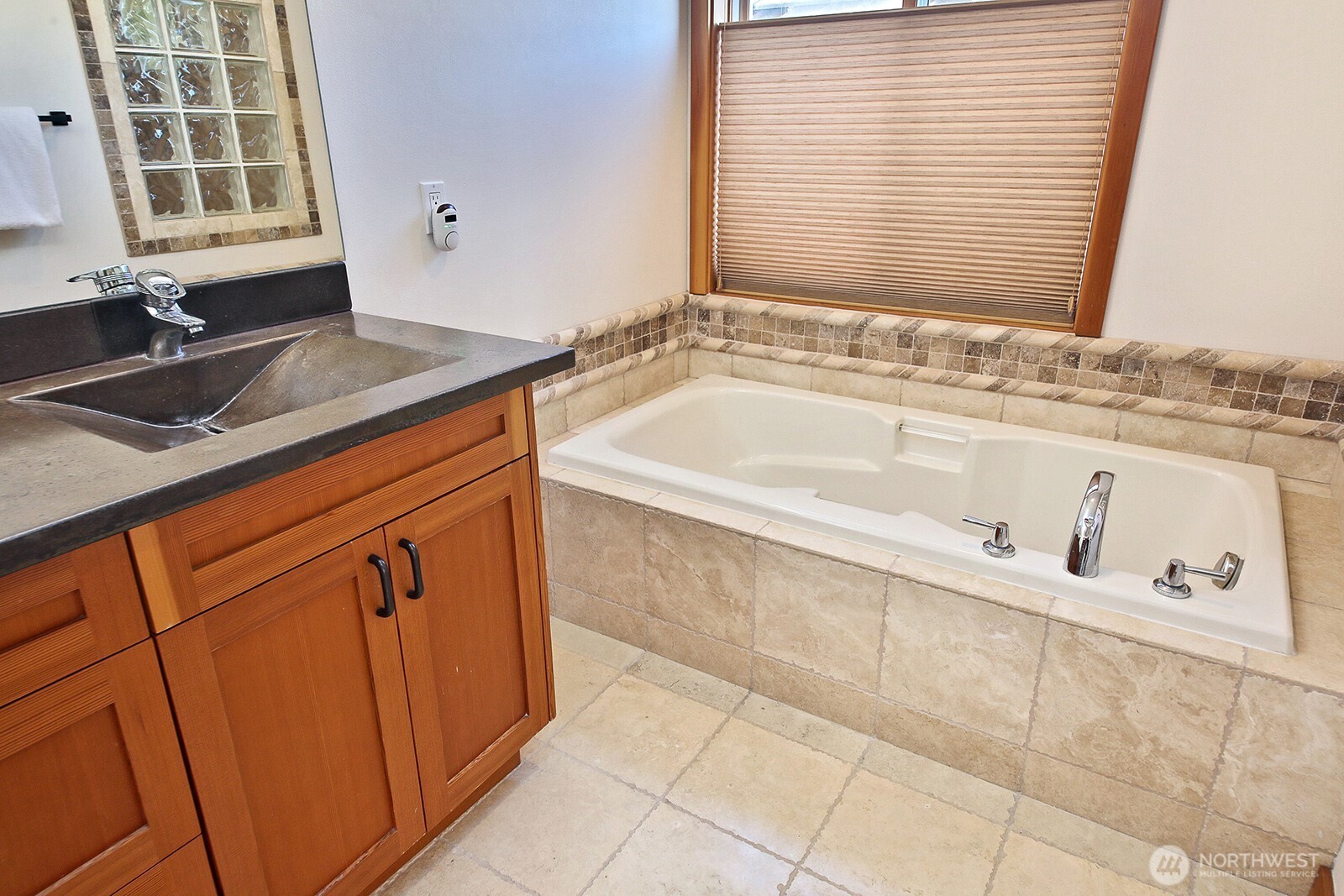 4913 Marshall Road Clinton, WA 98236 - Photo 25 of 40 a bathroom with a granite countertop sink and a bathtub