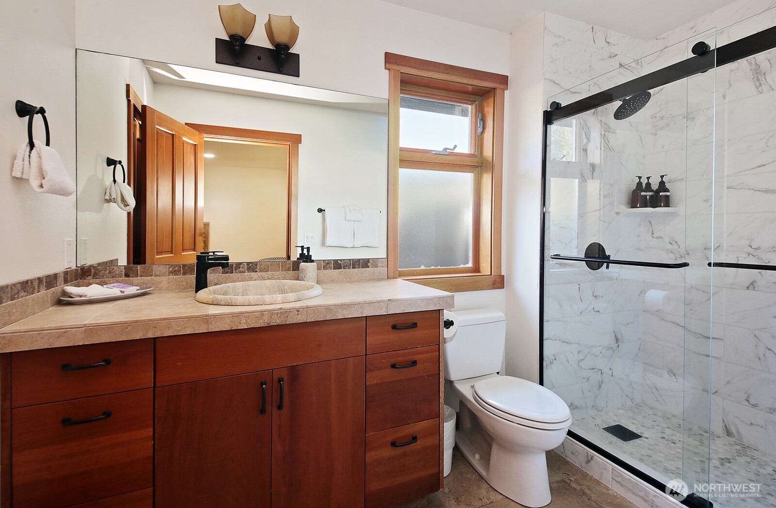 4913 Marshall Road Clinton, WA 98236 - Photo 29 of 40 a bathroom with a granite countertop sink toilet and shower