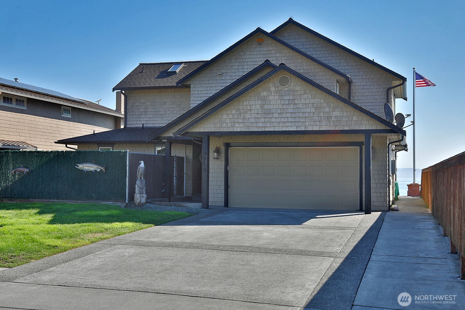 4913 Marshall Road Clinton, WA 98236 - Photo 10 of 40 a front view of a house with a yard and garage