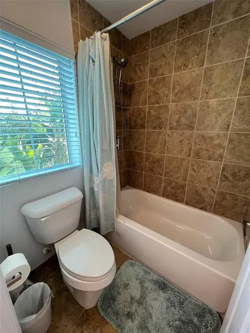 a bathroom with a toilet bathtub and shower