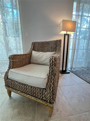 a bed sitting in a bedroom with a rug and a lamp