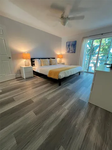 a bedroom with a bed and large window