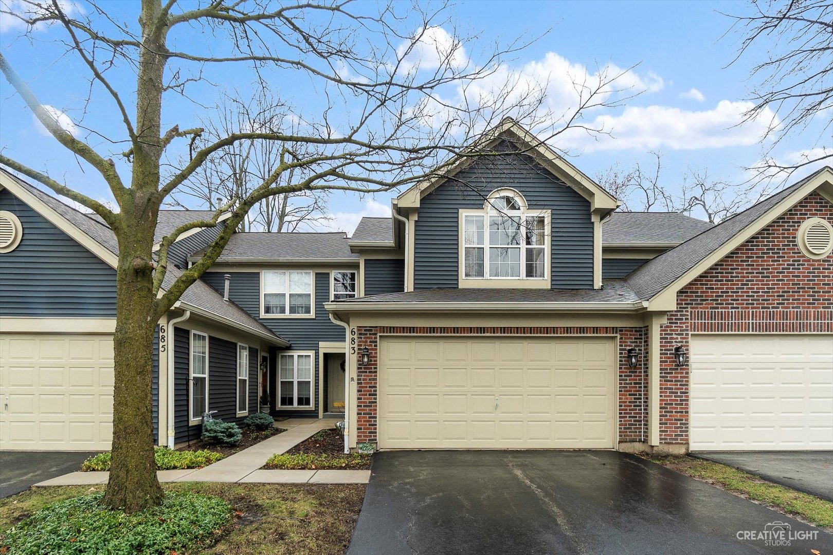 683 Bent Ridge Lane Elgin, IL 60120 - Photo 1 of 27 a front view of a house with a yard and garage