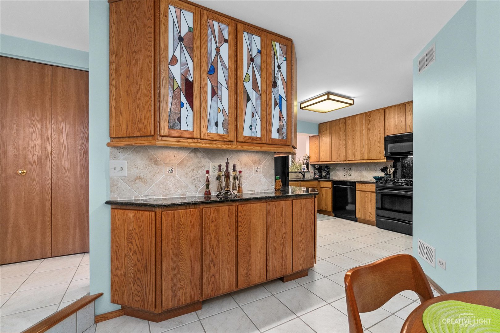 683 Bent Ridge Lane Elgin, IL 60120 - Photo 13 of 27 a kitchen with stainless steel appliances granite countertop a stove a sink and a refrigerator with wooden cabinets