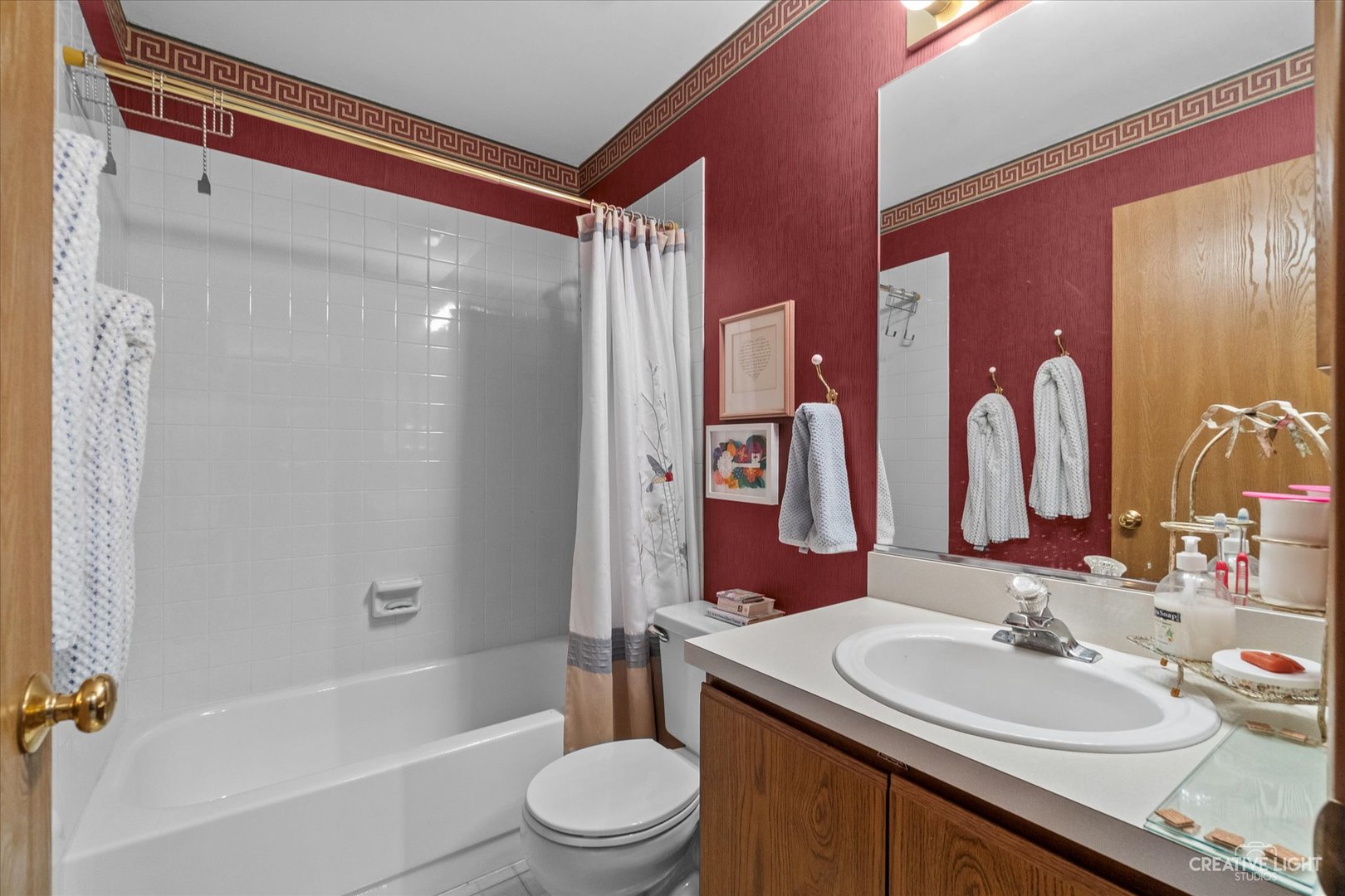 683 Bent Ridge Lane Elgin, IL 60120 - Photo 22 of 27 a bathroom with a sink a toilet a mirror a vanity a bathtub and shower