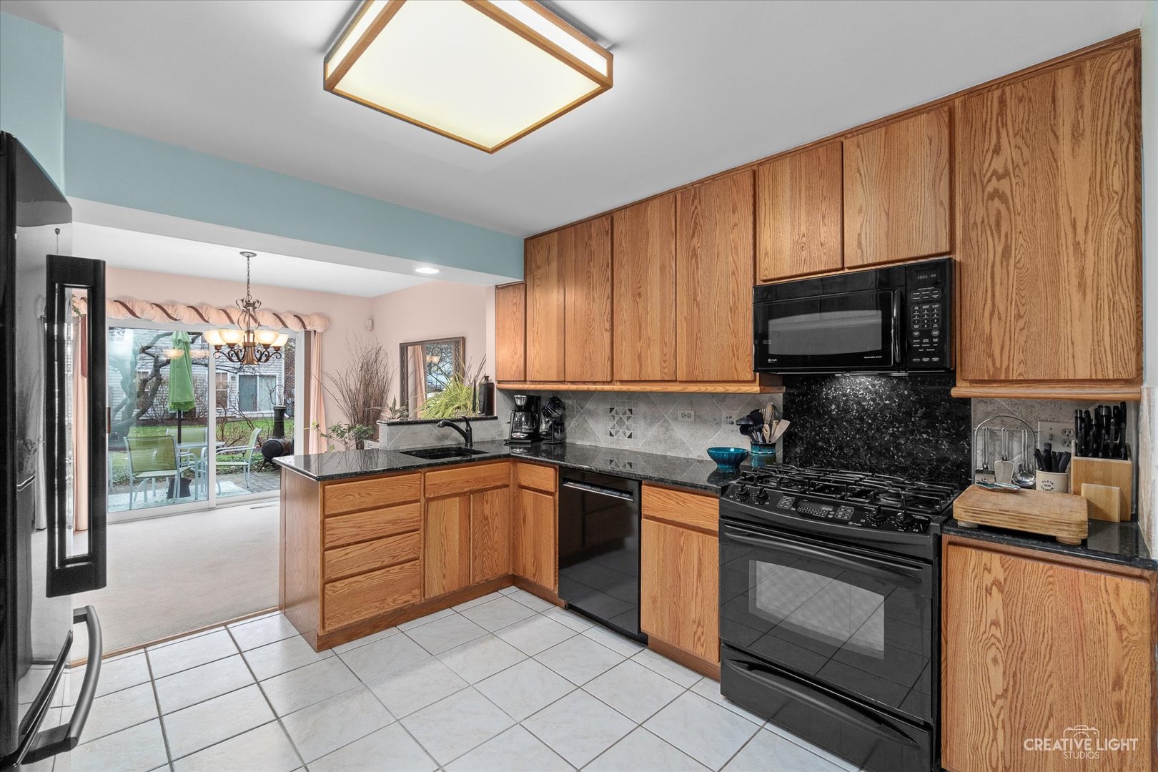 683 Bent Ridge Lane Elgin, IL 60120 - Photo 9 of 27 a kitchen with granite countertop a stove sink and cabinets