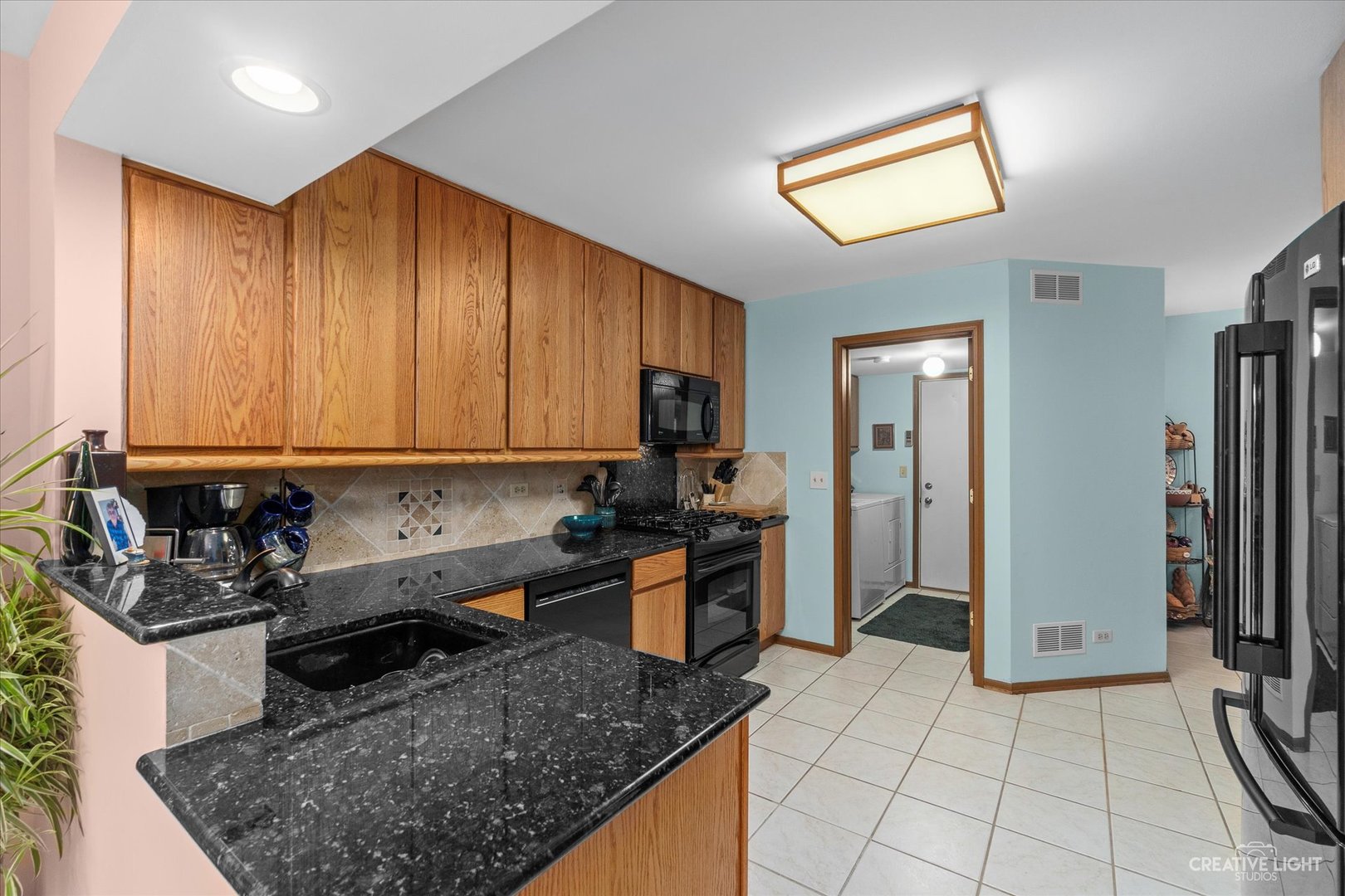 683 Bent Ridge Lane Elgin, IL 60120 - Photo 10 of 27 a kitchen with stainless steel appliances granite countertop a sink stove and refrigerator