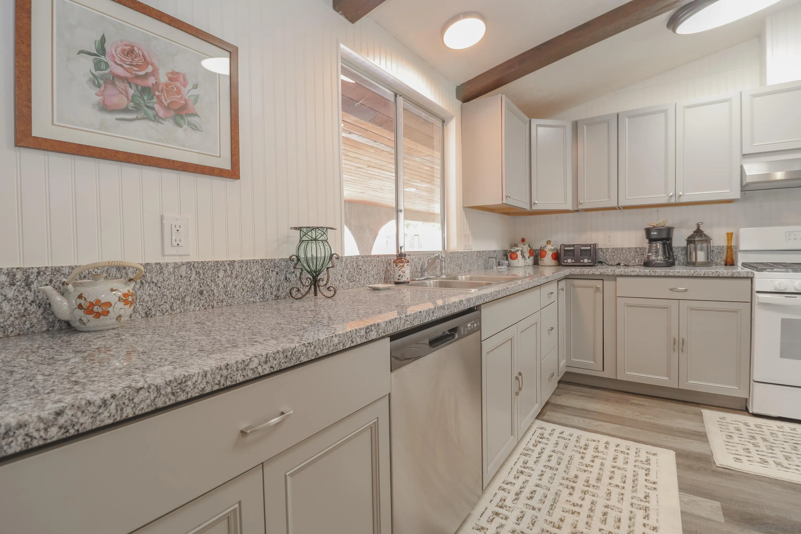 21141 Sharp Road Perris, CA 92570 - Photo 18 of 43 a kitchen with a sink stove and cabinets