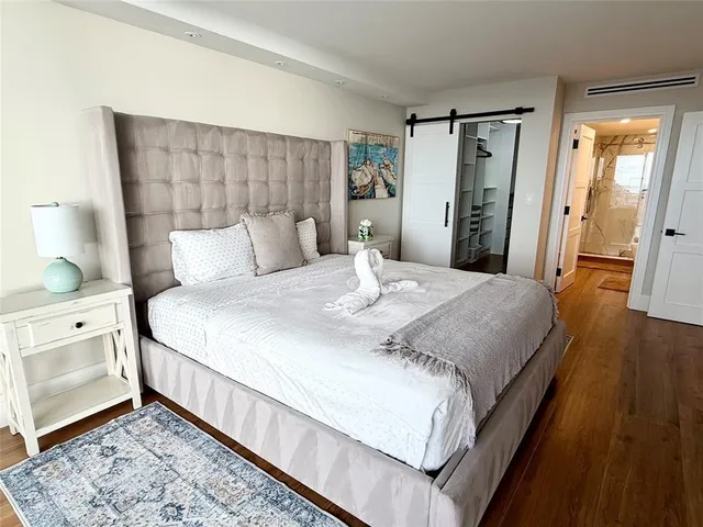 a bedroom with a bed and a dresser