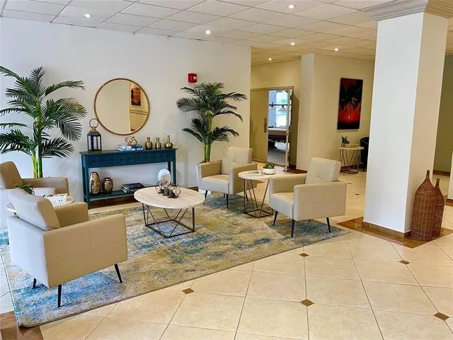 a living room with fireplace a glass top table and chairs