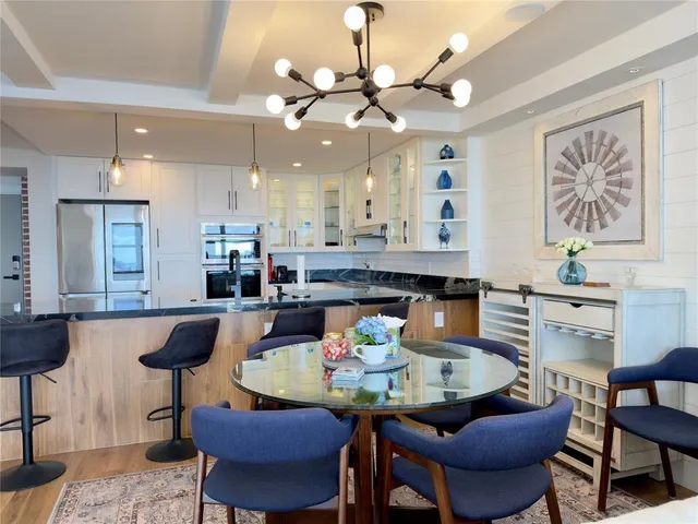 a kitchen with a dining table cabinets and window