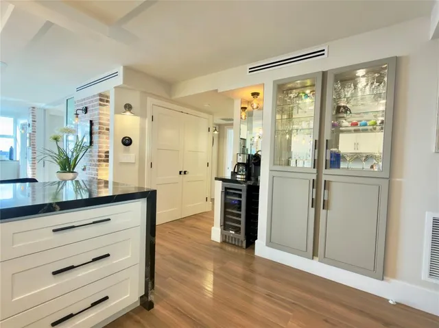 a view of a living room with furniture and wooden floor