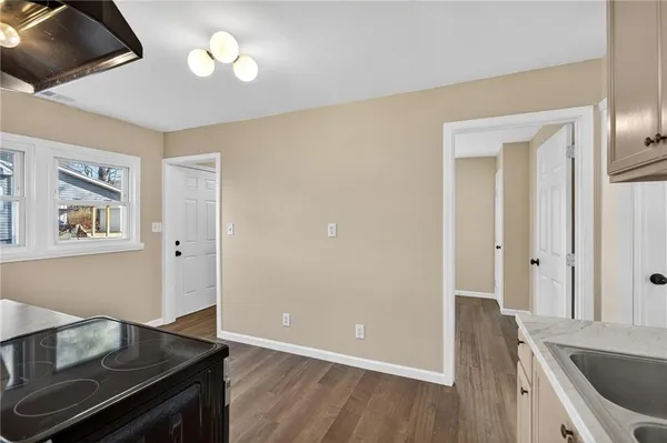 a view of an empty room and wooden floor