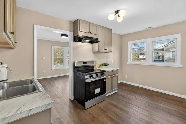 a kitchen with stainless steel appliances granite countertop a stove and a sink