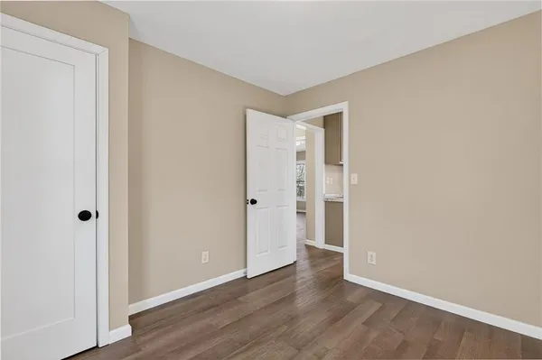 a view of an empty room and wooden floor