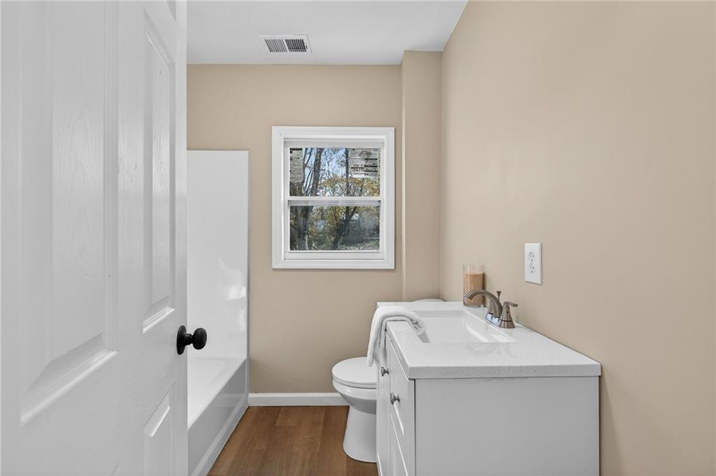 562 Highland Avenue Summerville, GA 30747 - Photo 25 of 27 a bathroom with a sink toilet and shower