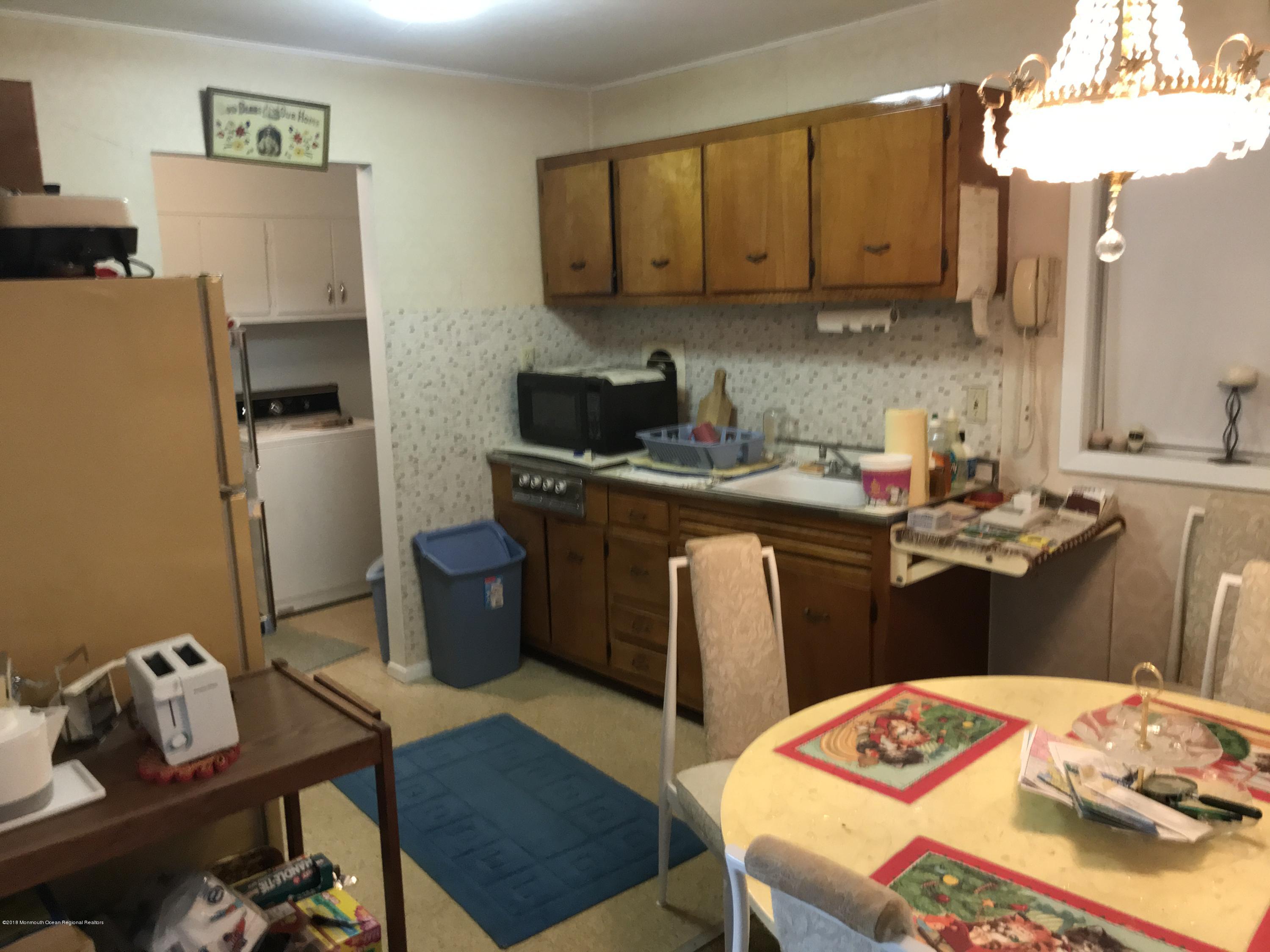 28 Mallard Road Bayville, NJ 08721 - Photo 6 of 8 a bedroom with a bed and a table in it