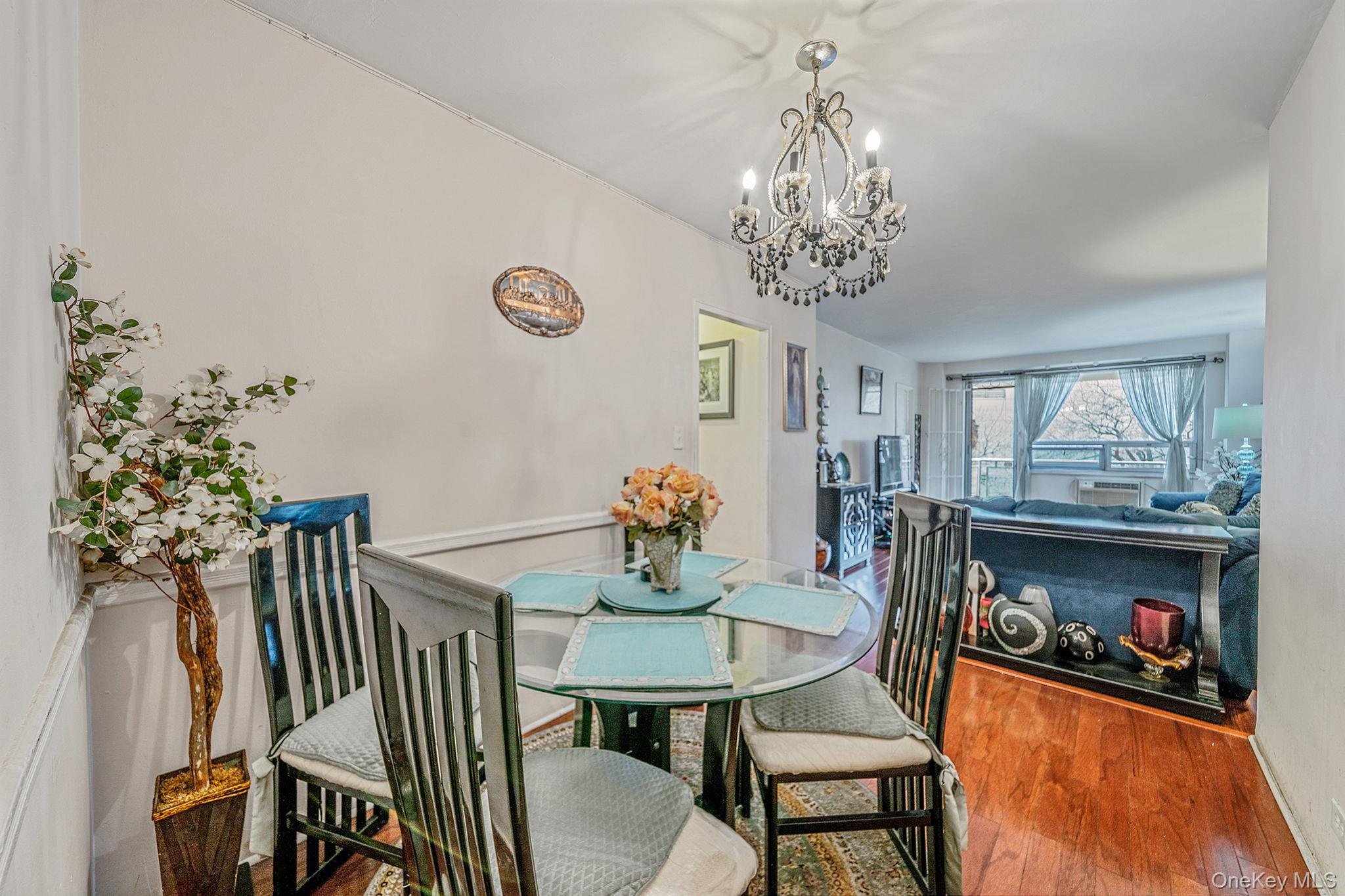 a view of a dining room with furniture and chandelier