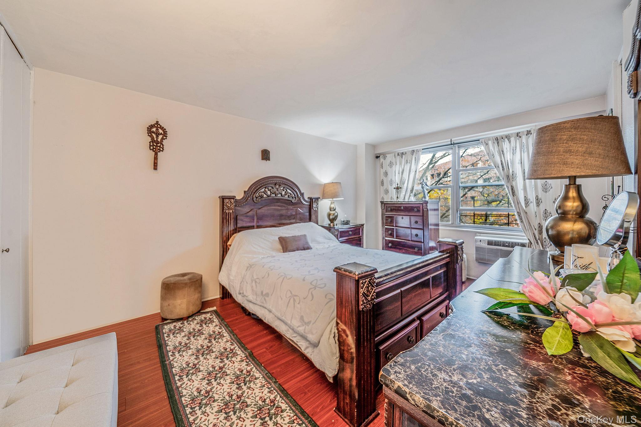 61-25 97th Street, Unit 2B Queens, NY 11374 - Photo 13 of 22 a bedroom with a bed table closet and window