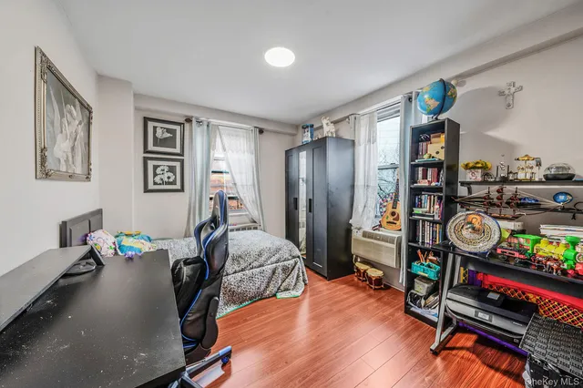 a bedroom with furniture and a book shelf