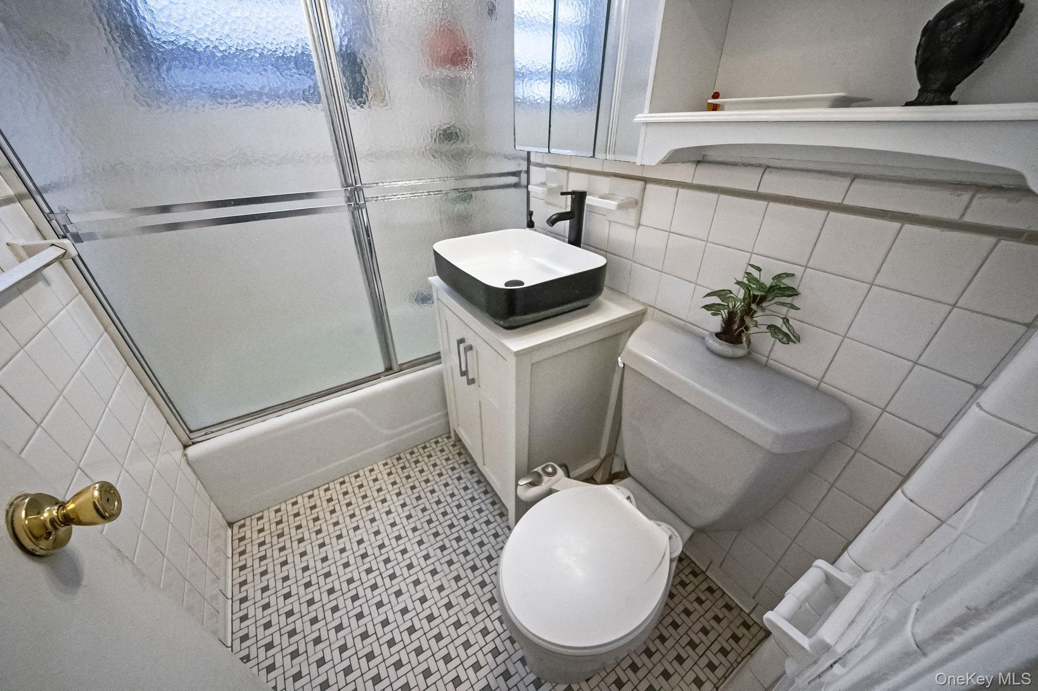 61-25 97th Street, Unit 2B Queens, NY 11374 - Photo 17 of 22 a bathroom with a sink toilet and shower
