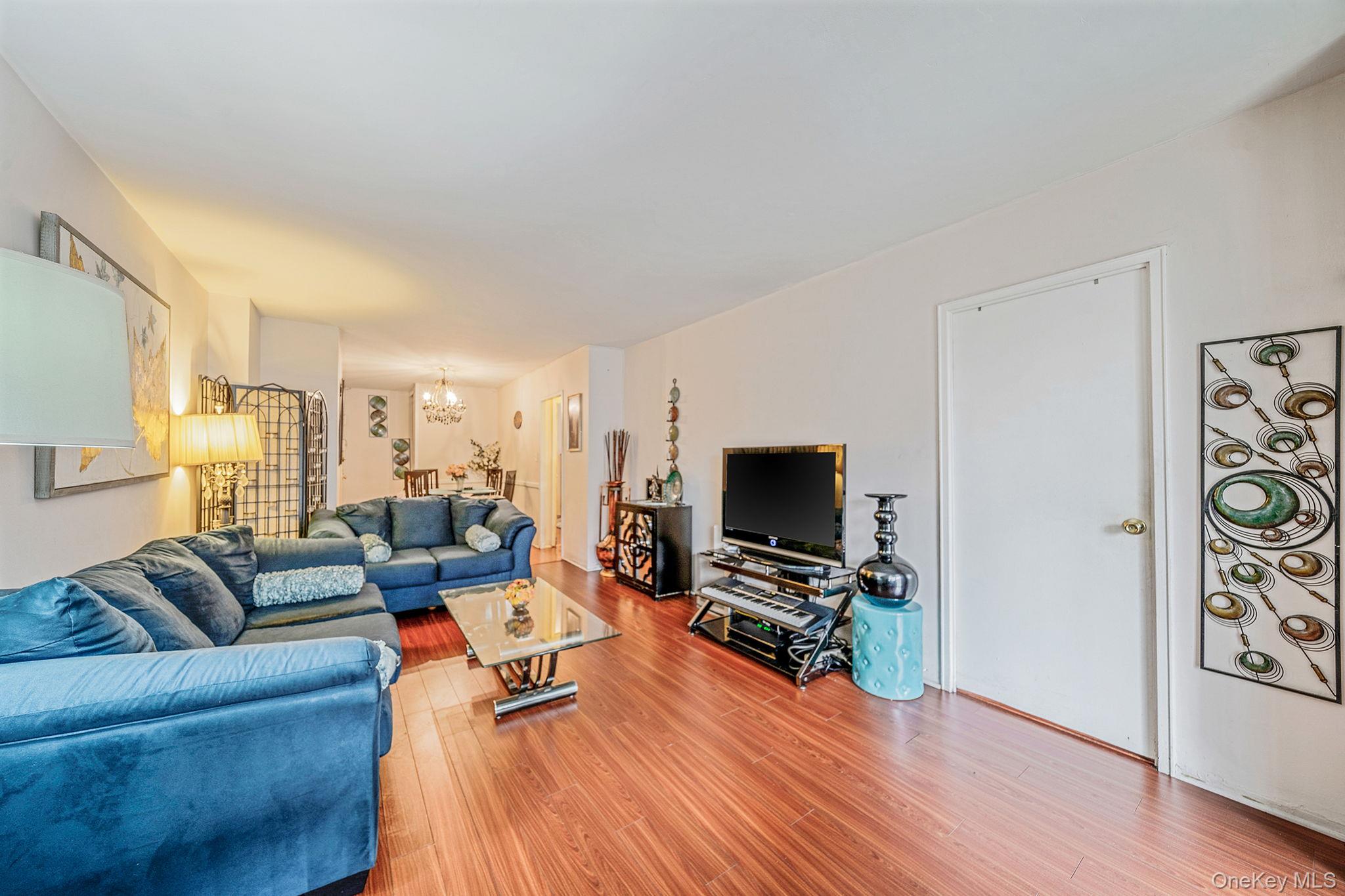 61-25 97th Street, Unit 2B Queens, NY 11374 - Photo 4 of 22 a living room with furniture and a flat screen tv