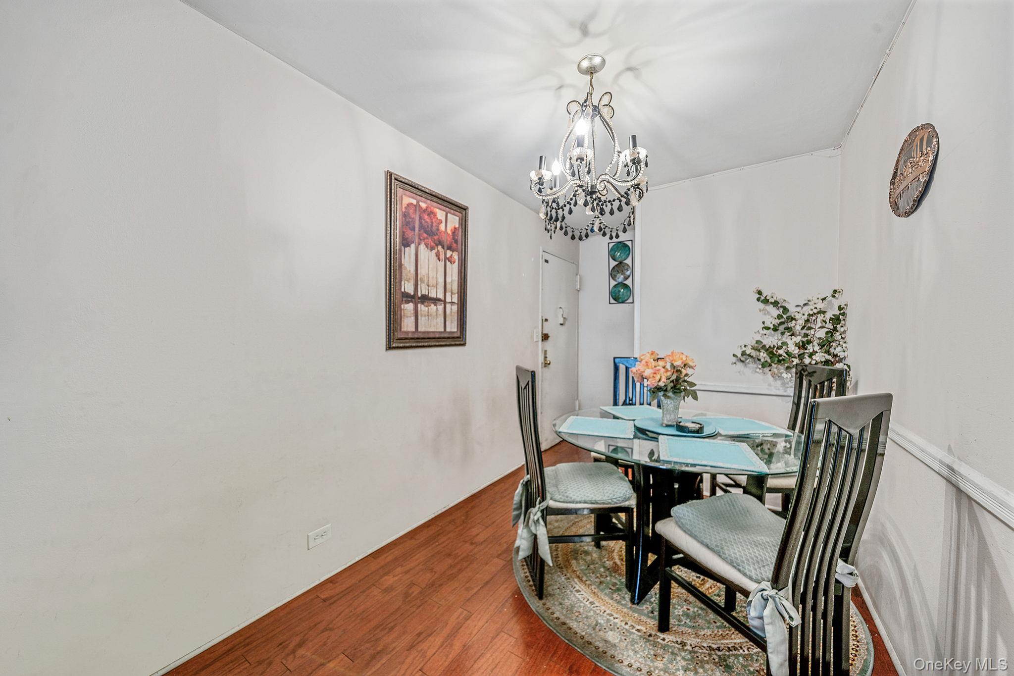 61-25 97th Street, Unit 2B Queens, NY 11374 - Photo 5 of 22 a view of a dining room with furniture and chandelier