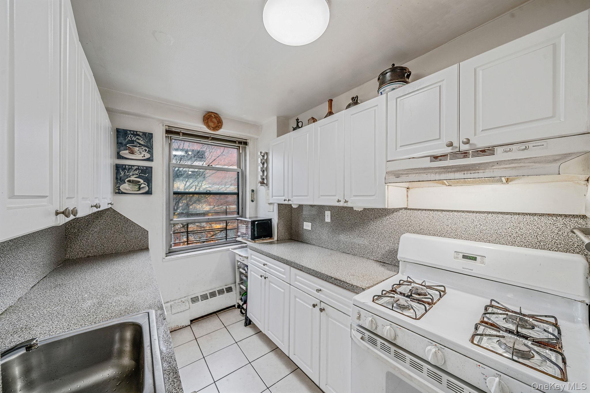 61-25 97th Street, Unit 2B Queens, NY 11374 - Photo 9 of 22 a kitchen with stainless steel appliances granite countertop a sink and cabinets