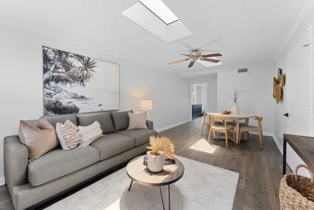 a living room with furniture a table and a chandelier