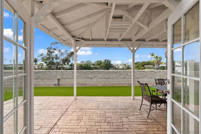 a view of a porch with a table chairs and wooden fence
