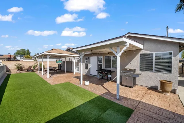 a view of a house with backyard sitting area and garden