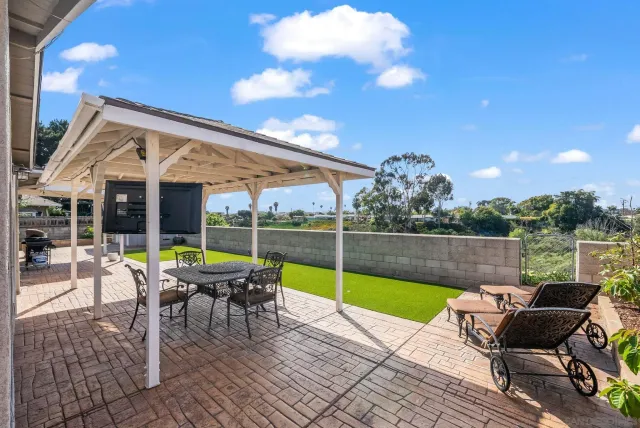 a view of a patio with a table and chairs