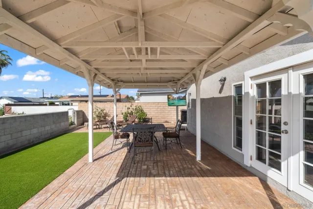 a view of a porch with furniture and a yard