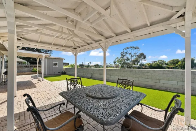 a view of a patio with a table and chairs