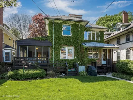 a view of a house with a yard porch and sitting area